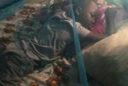 Joseph under his mosquito net