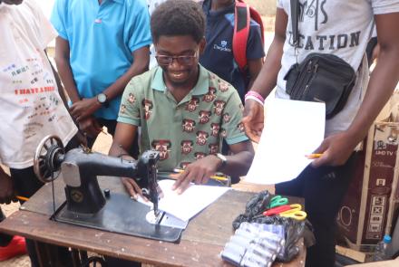 A Mentee Learning how to use a Sewing Machine
