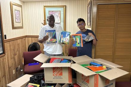 Aharshi with Sylvester - school supplies drop off at Develop Africa's office