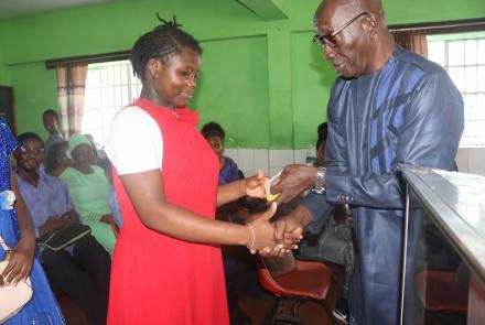 Girl receiving SolarBuddy lamp - Sierra Leone July, 2026