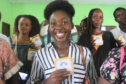 Kamara holding SolarBuddy lamp - Sierra Leone July, 2026