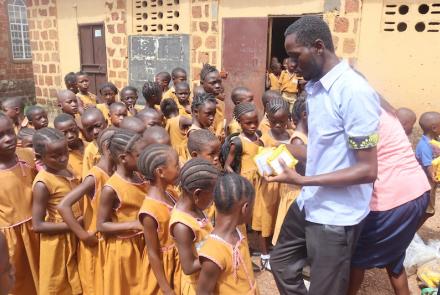 Staff distributing SolarBuddy lamps to kids - Sierra Leone - July 2026