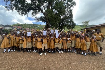 Students at REC Primary School Bathurst, Sierra Leone with SolarBuddy lamp