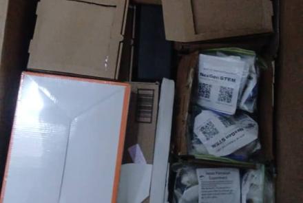 cartons of science kits donated by NEXGEN STEM