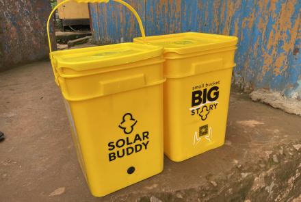 SolarBuddy bucket filled with SolarBuddy lamps