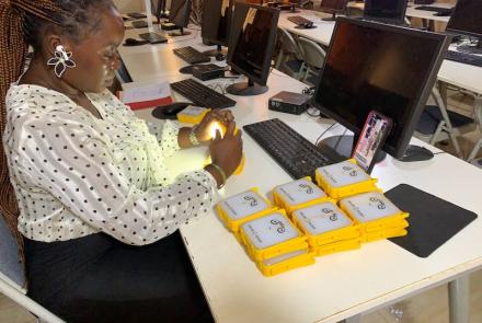 Staff packing SolarBuddy lamps - Develop Africa Sierra Leone, July 2026