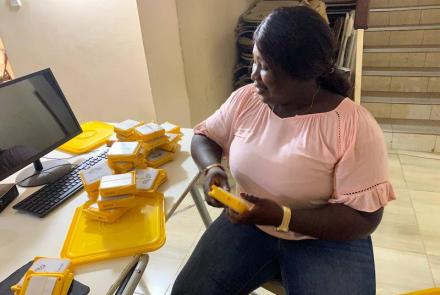 Thomascia, beneficiary packing SolarBuddy lamps - Sierra Leone