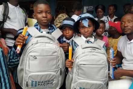 Young Students with bookbags and school supplies